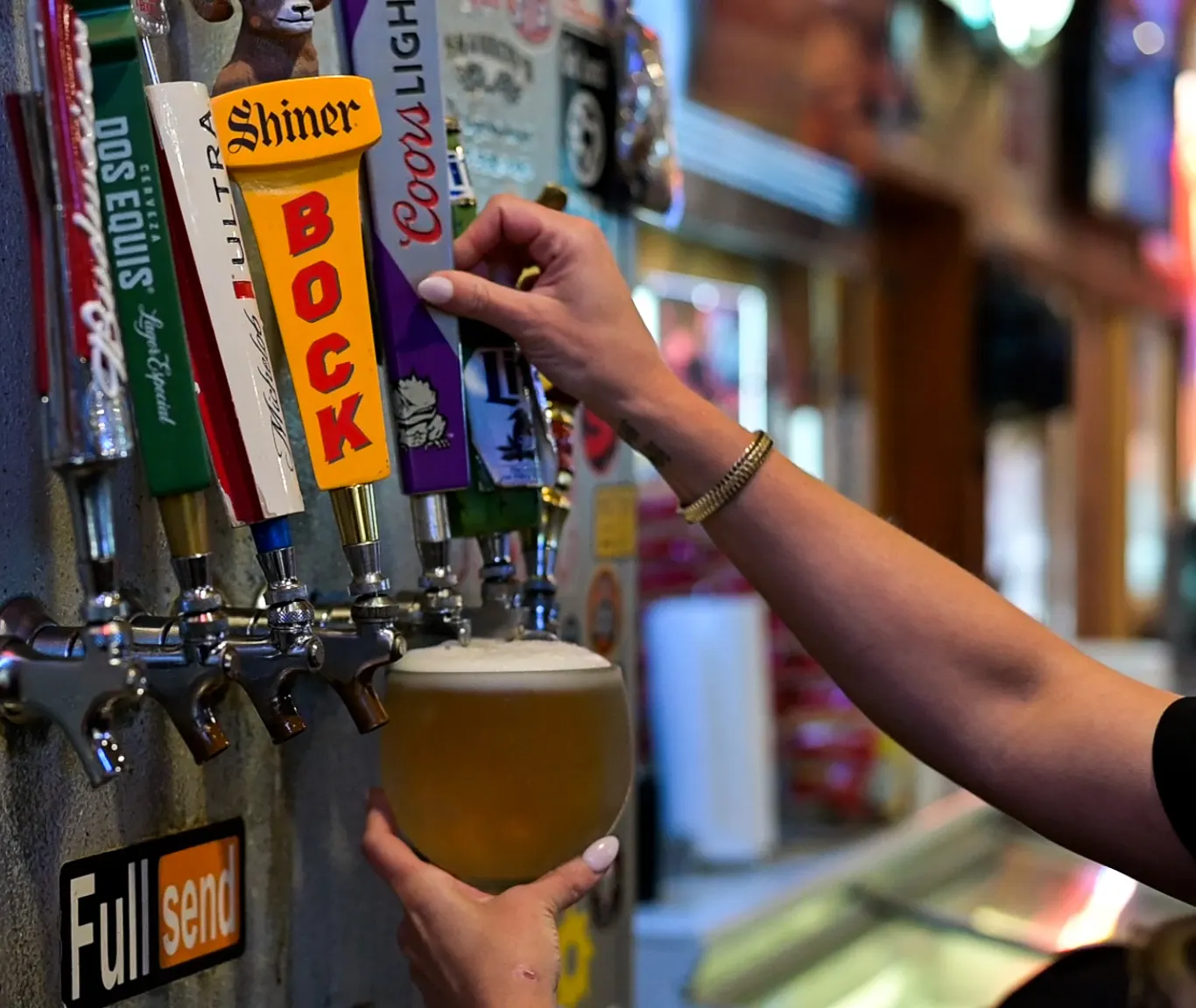 A cold draft beer poured from the tap wall at Sammies Bar-B-Q in Fort Worth, TX